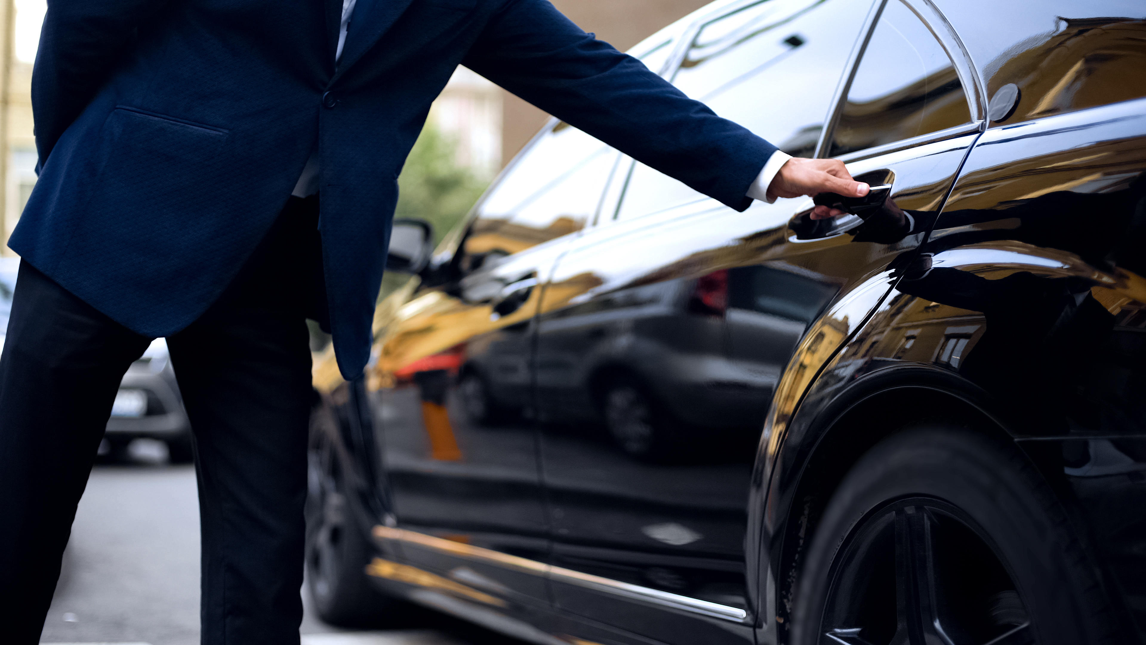 Personal driver opening backseat door in car for successful businessman, service professional-driver-chauffeur-service